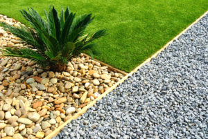 Landscape edging with grass, plant and stones